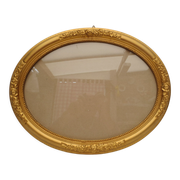 Large old oval gilded wooden frame and stucco decorations