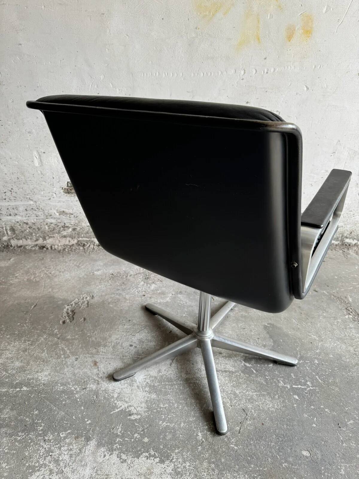 Wilkhahn Delta lounge chair in black leather with polished aluminum base and footrest (1970s)