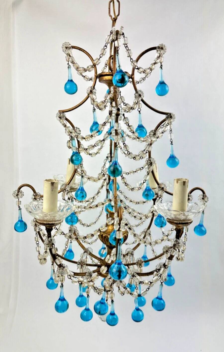 Italian chandelier with blue beads and gilded wood.