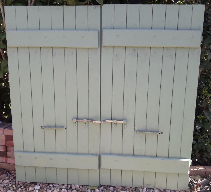 Pair of wooden shutters hanging iron