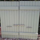 Pair of wooden shutters hanging iron