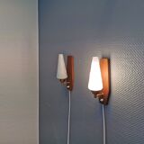 Danish wall lights from the 1970s, made of milky white glass shades, teak wood suspension and brass.