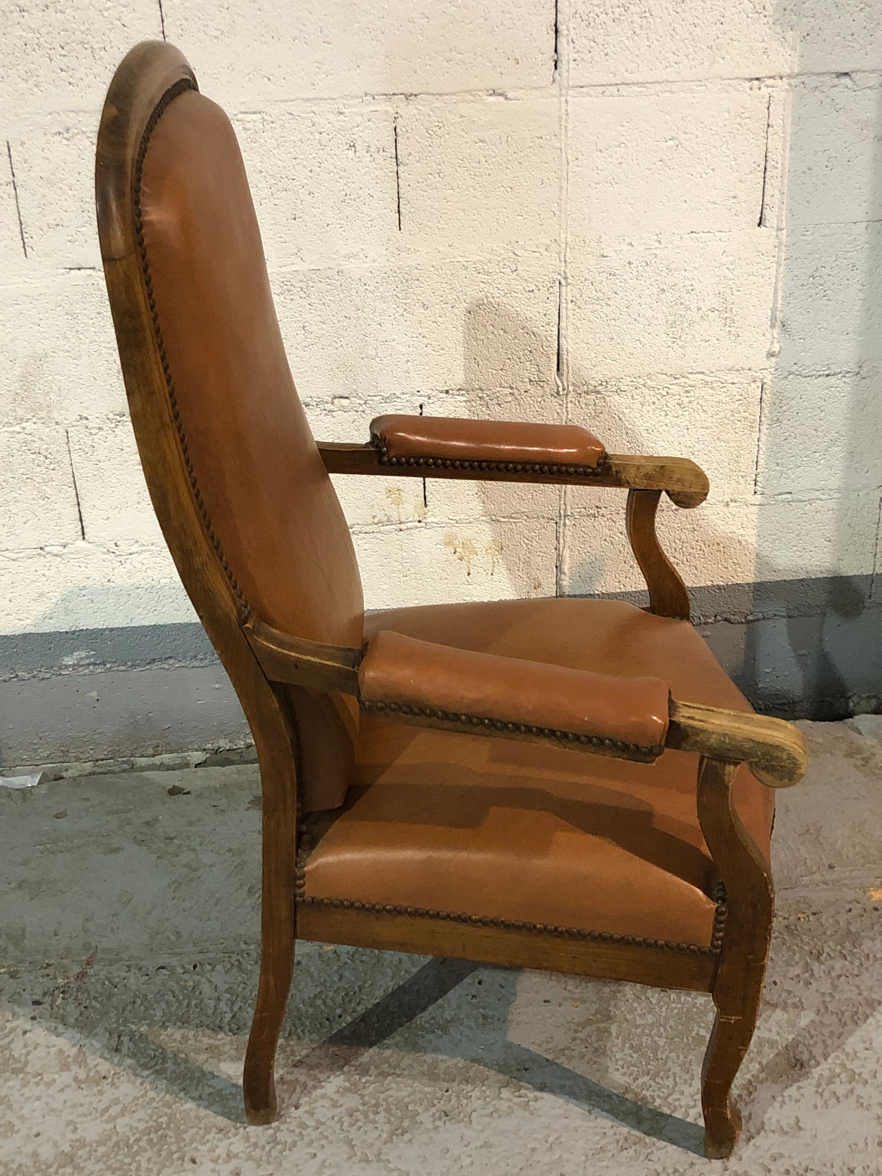 Old Voltaire armchair in light brown leather