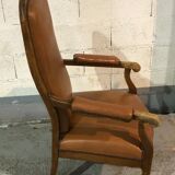 Old Voltaire armchair in light brown leather