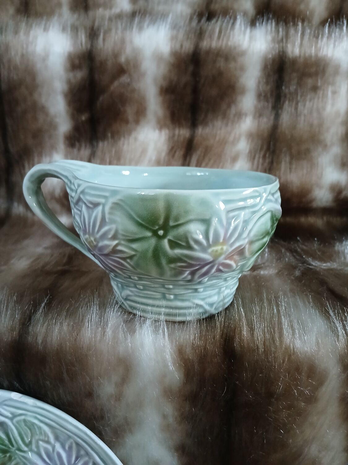 Antique cup and saucer in majolica.
