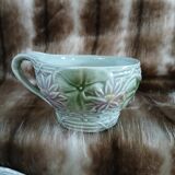 Antique cup and saucer in majolica.