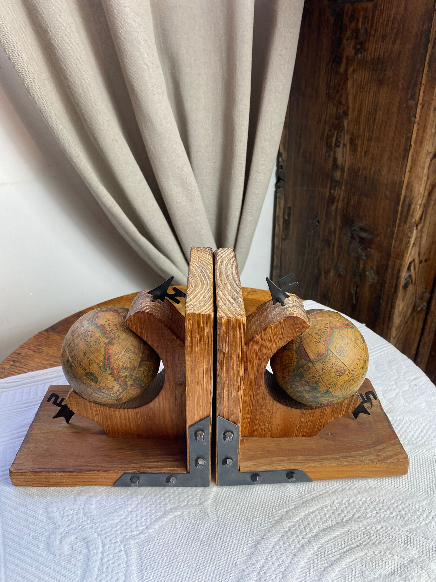 Pair of wooden bookends, rotating globes