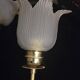 Frosted glass wall sconces and gilded brass in Art Deco style.