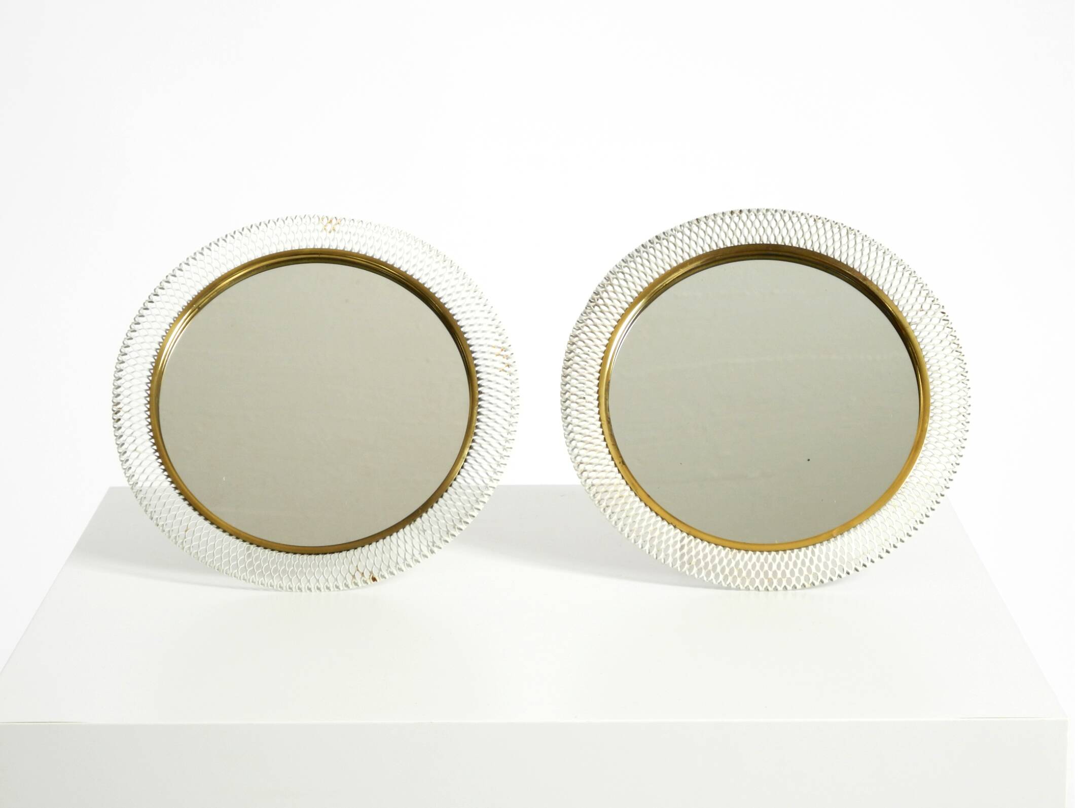 Pair of rare small Mid Century Modern table mirrors with expanded metal fra
