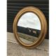 Gold oval mirror 64cm x 54cm