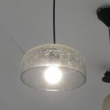 Modern suspended lamp in cracked blown glass, minimalist design.