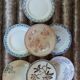 13 mismatched flat plates in ironstone
