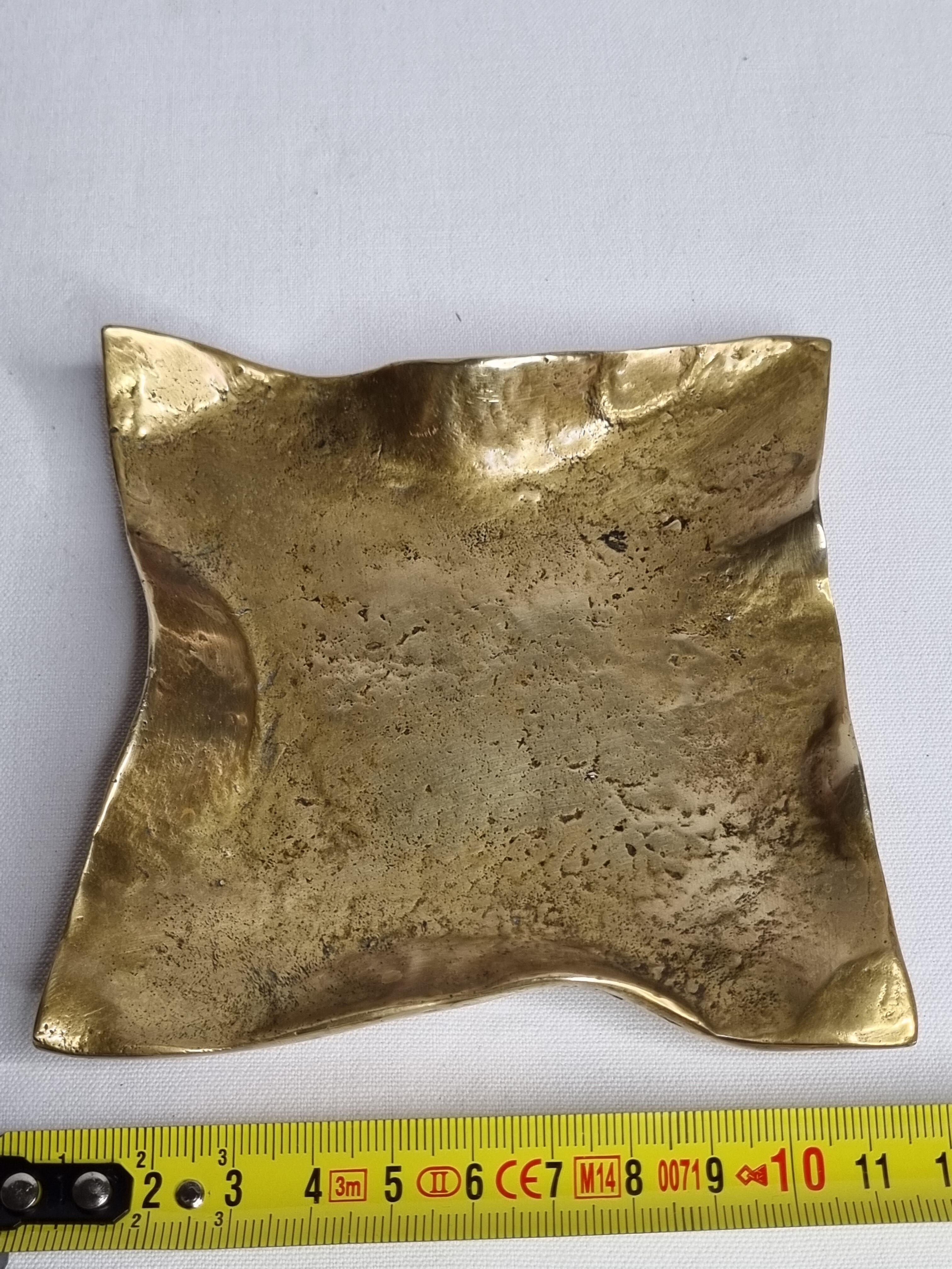 Empty pocket in polished brass representing a crumpled paper, signed CJ, 11.5 cm