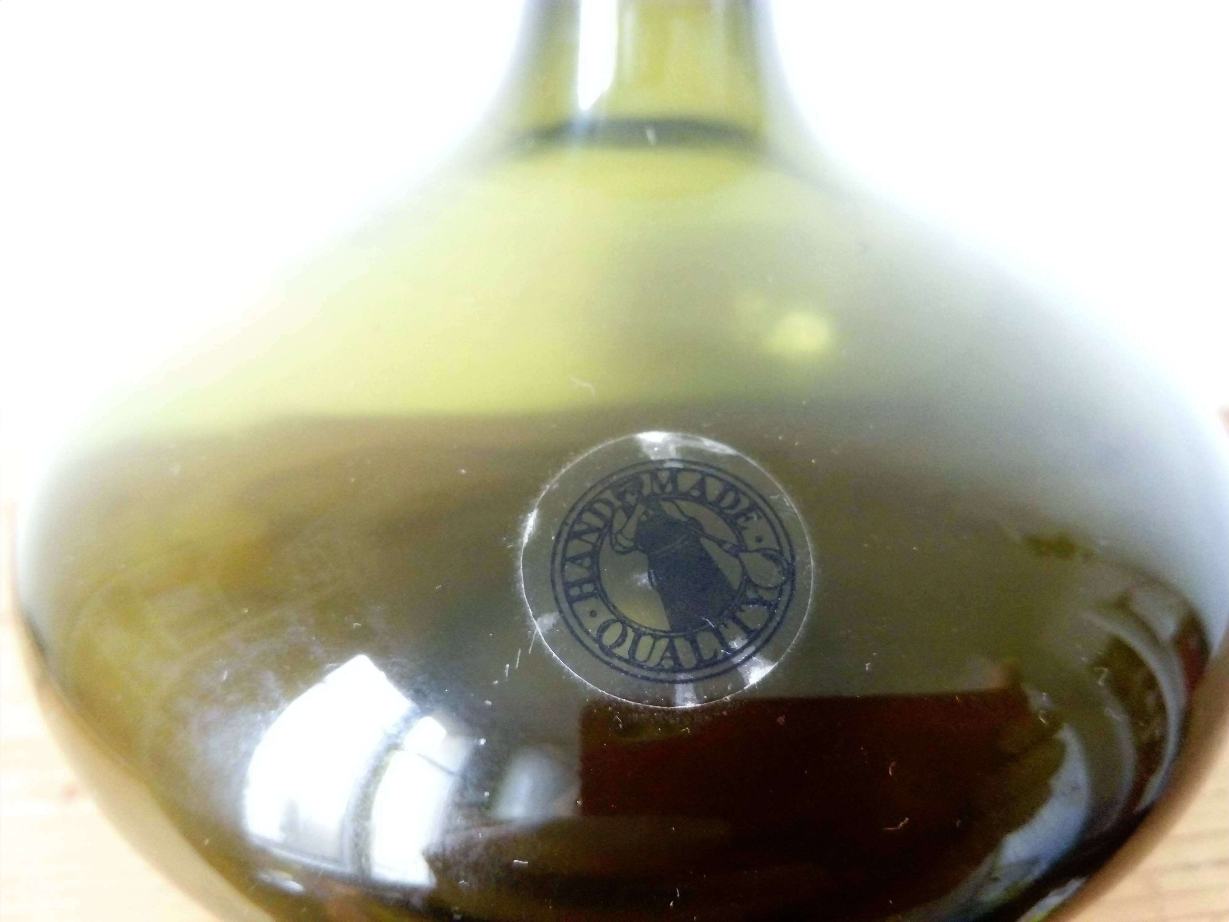 Small dark green handmade glass ball vase