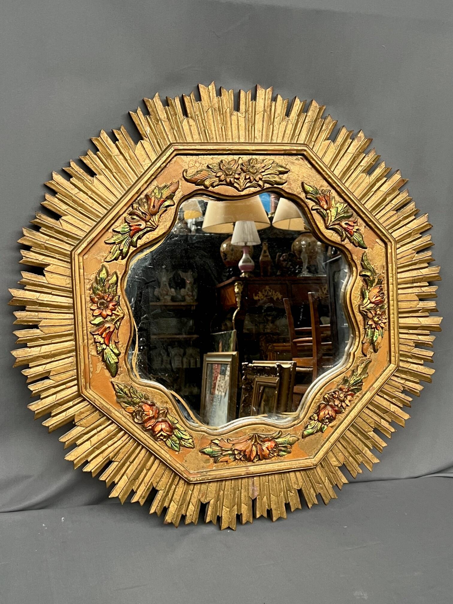 Large wooden mirror with golden sunbeams, Art Deco style.