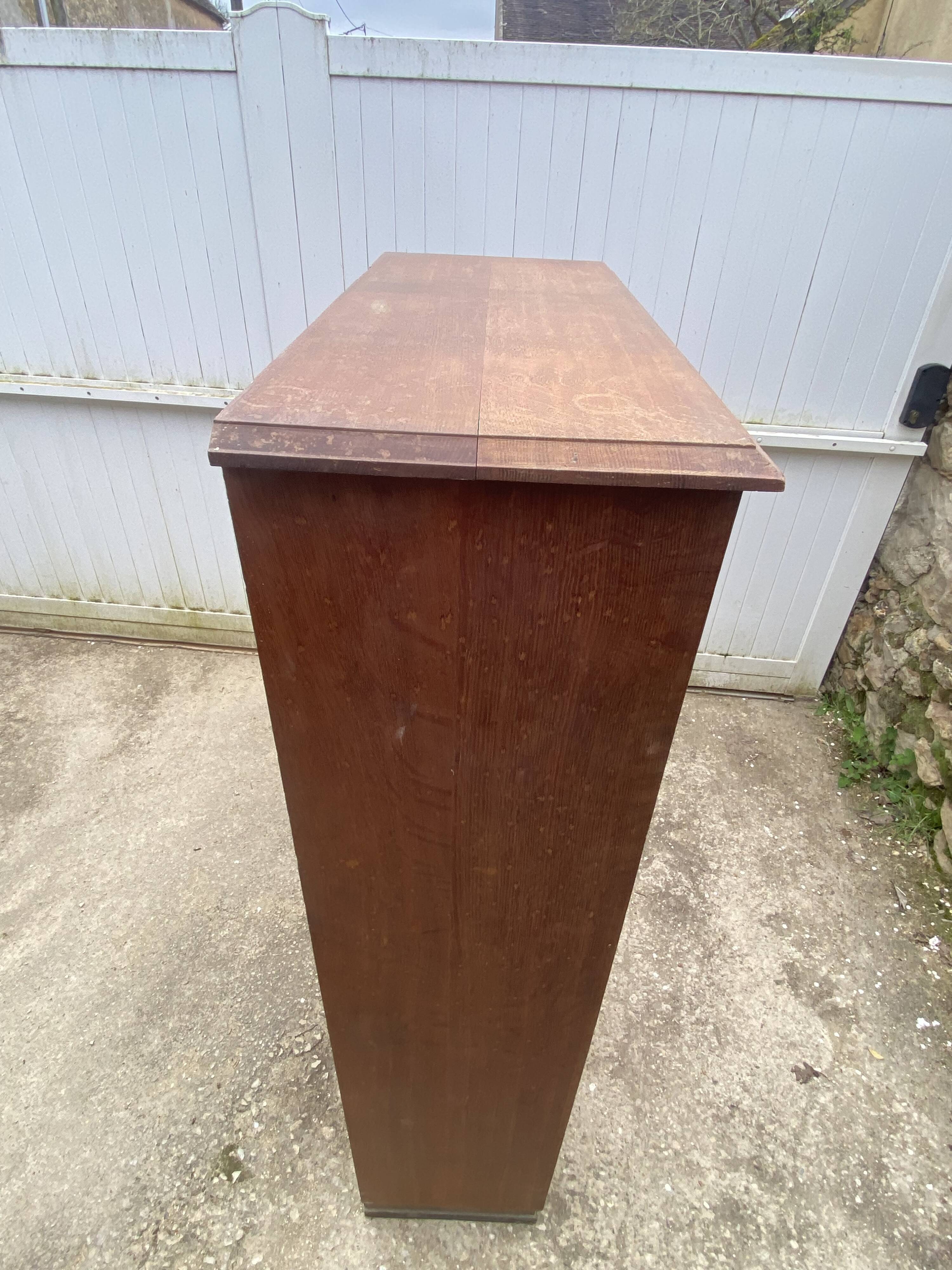 Oak two-column filing cabinet with curtains.