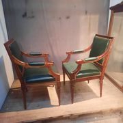 Pair of Louis XVI style armchairs upholstered in green leather.