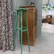 Vintage wooden stool with green patina.