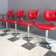 Quatre chaises de barbier en cuir rouge des années 1960 avec accoudoirs bakelite
