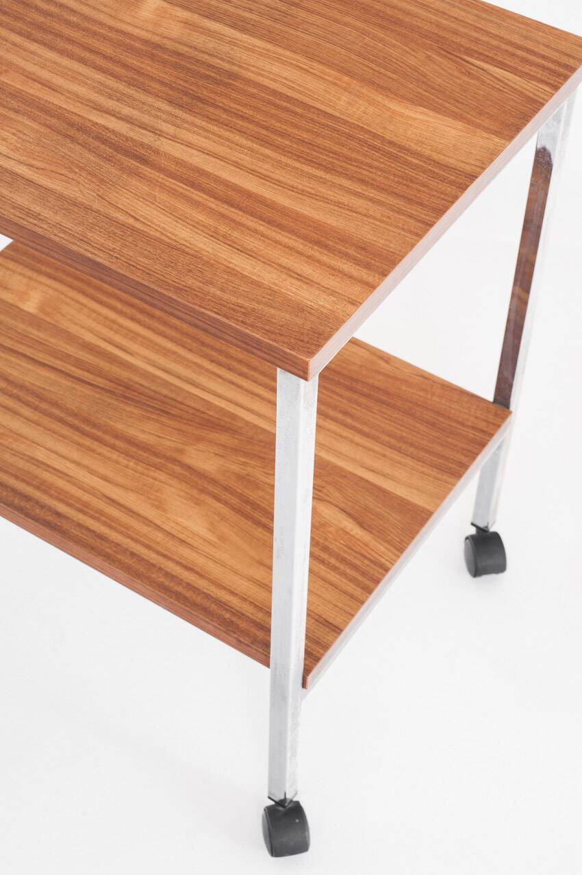 Vintage side table on wheels. Chrome-plated iron tube and wood. France, 1970s.