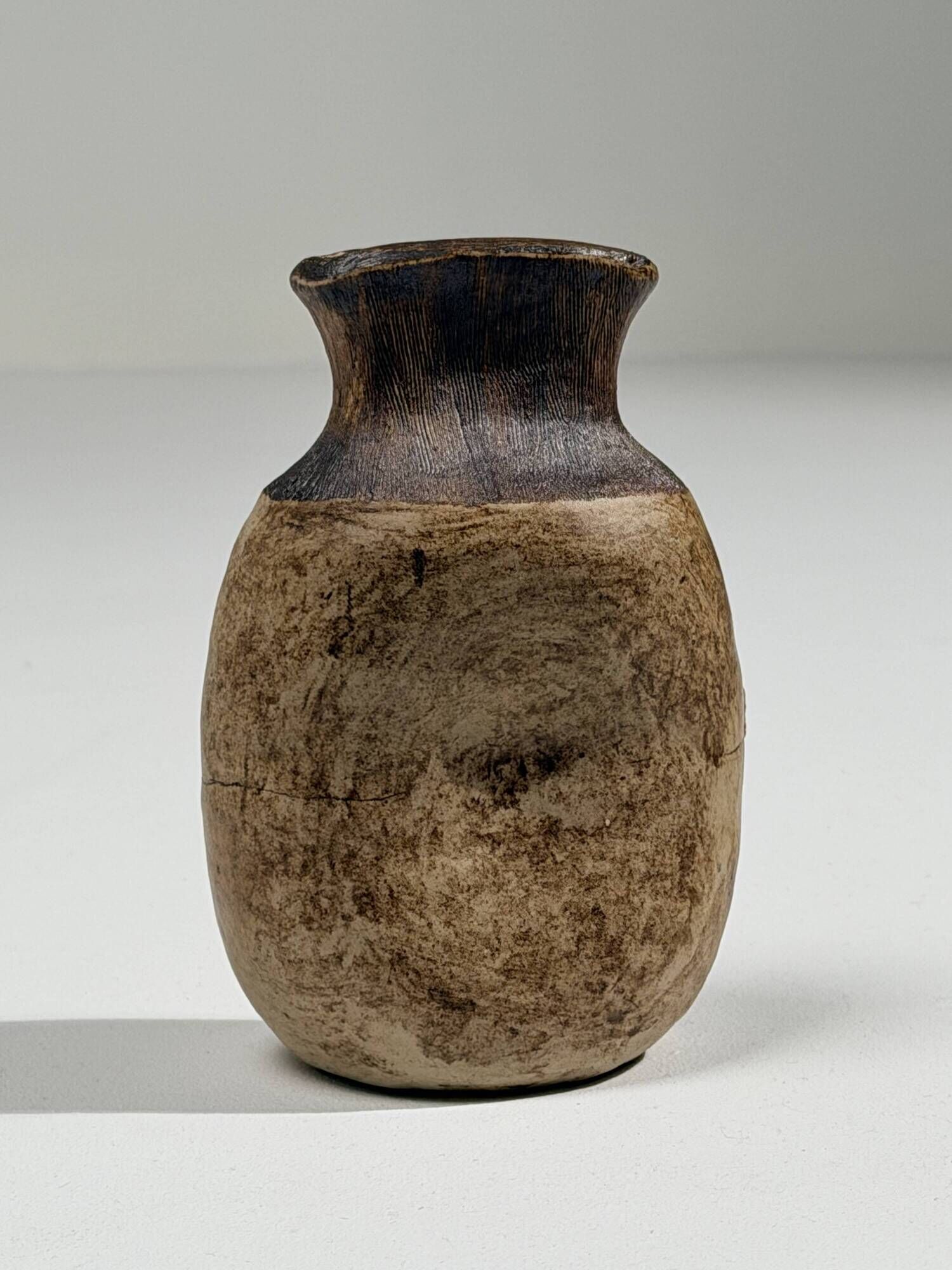 Small brutalist stoneware vase with a ribbed neck, France, circa 1960.