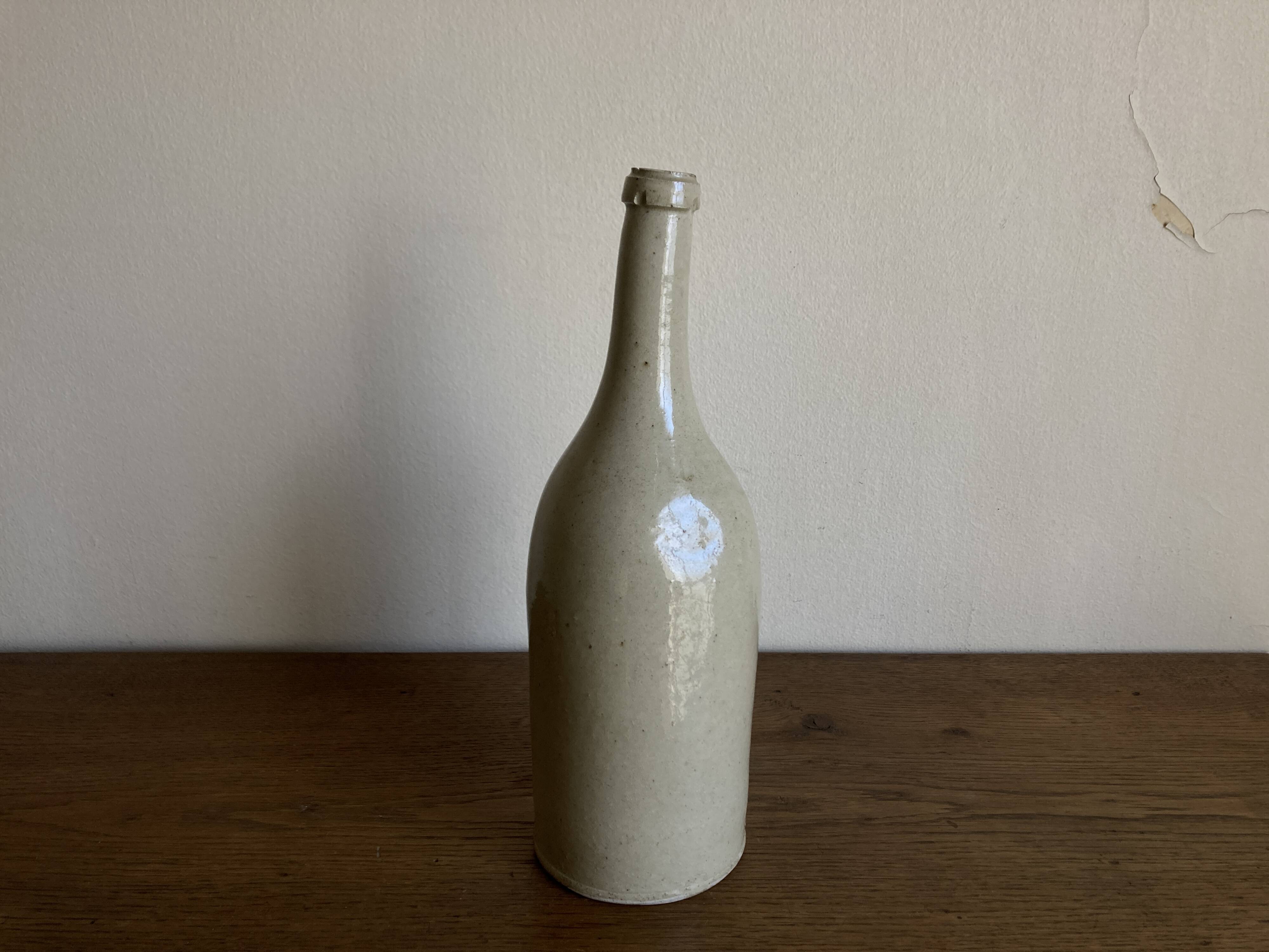 Stoneware bottle tilted at an angle, early 20th century