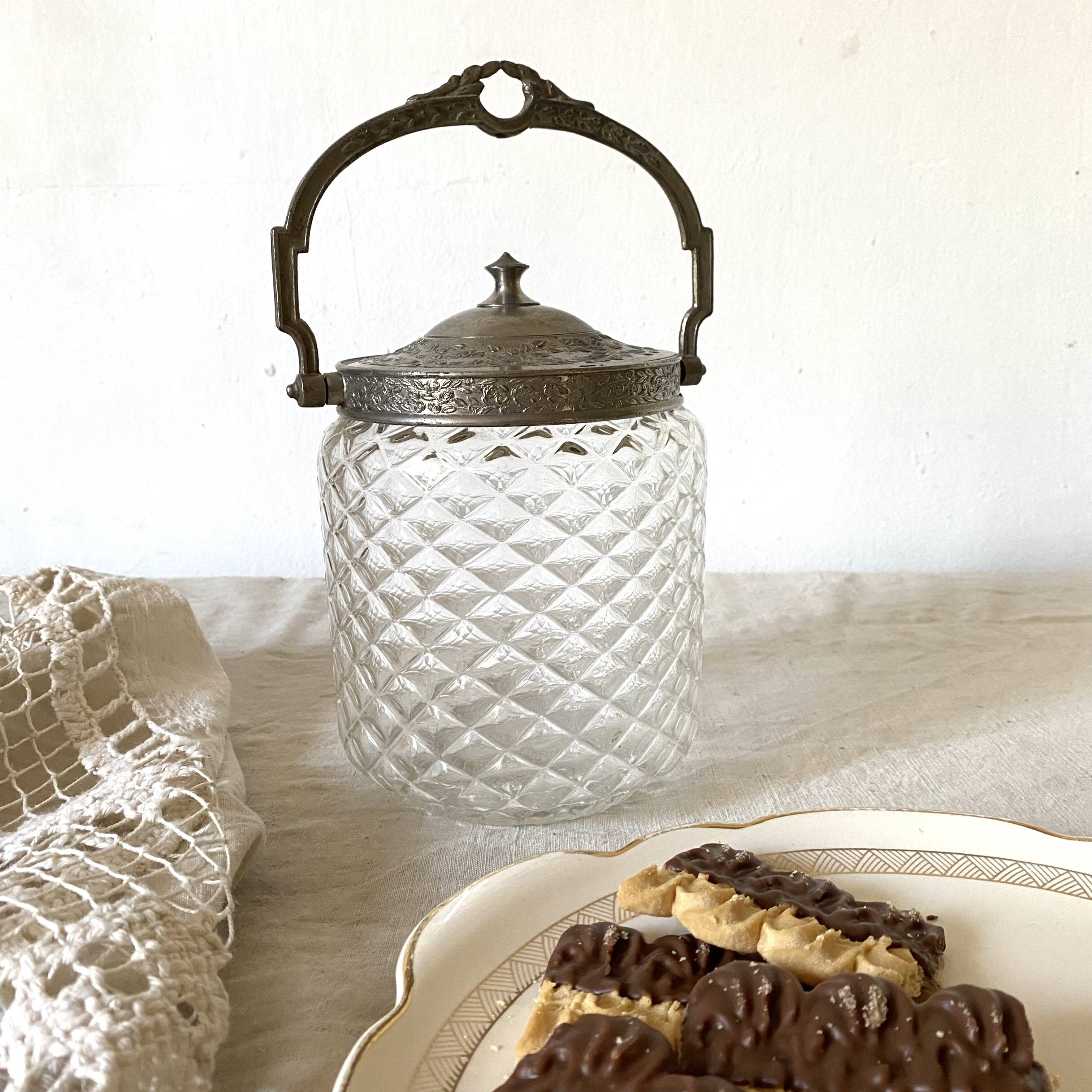 Old biscuit bucket in glass and metal