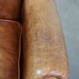 Graceful, stylish, timeless and comfortable wing chair made of cowhide in English style