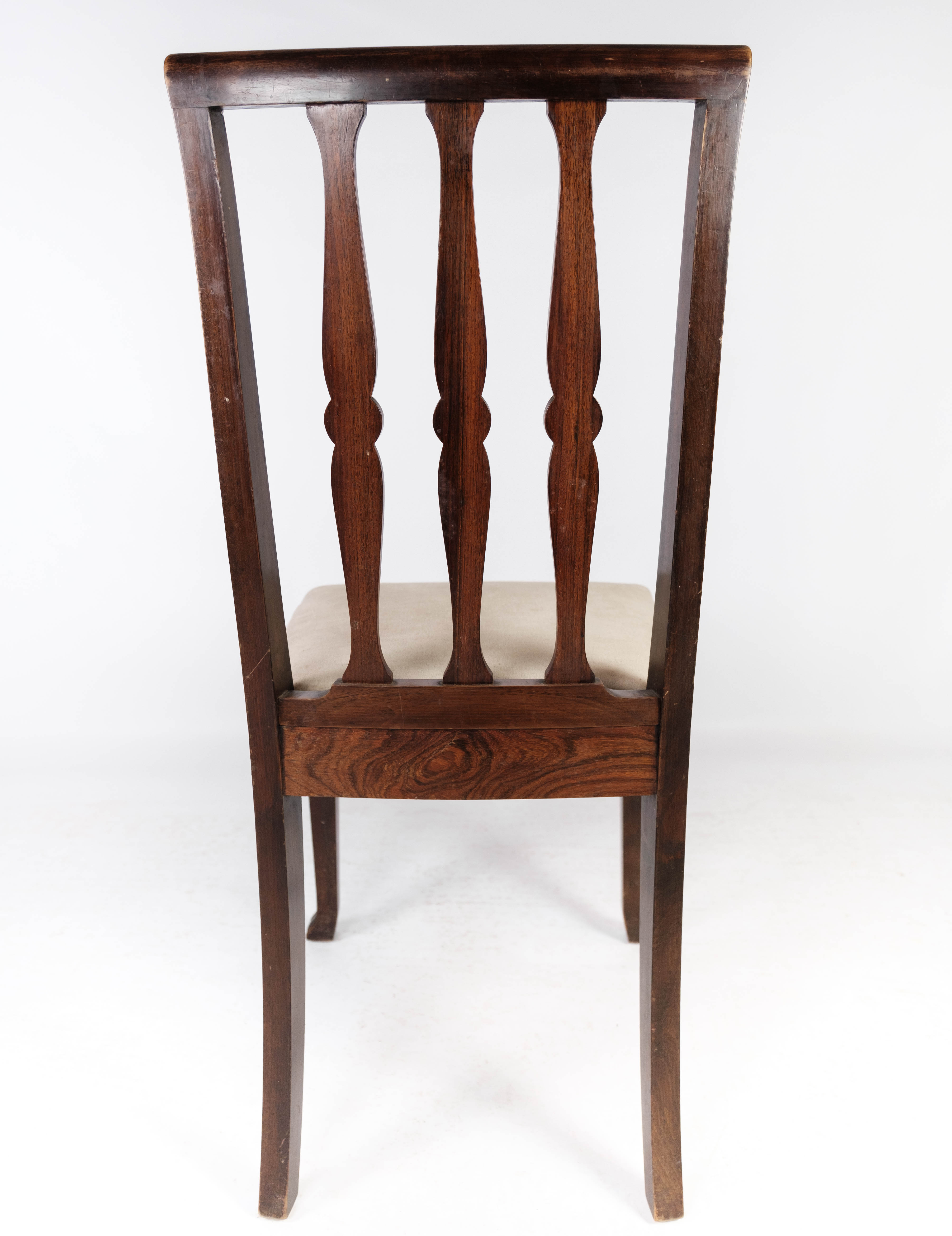 Set of four dining room chairs in rosewood and upholstered with light fabric, 1920s