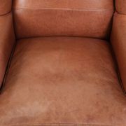 Light cognac-coloured English wingback armchair made of cowhide leather