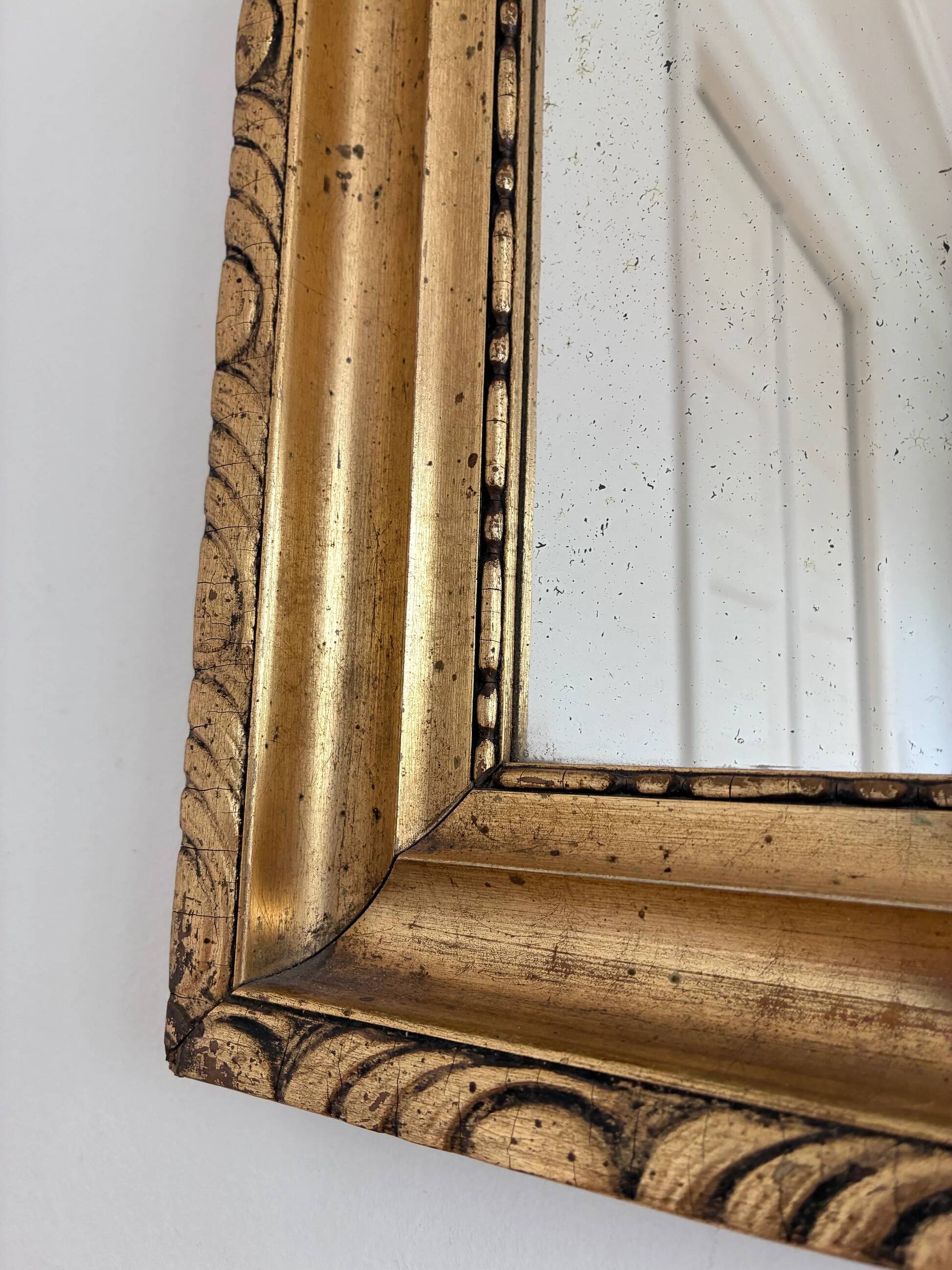 Antique French giltwood wall mirror in gold