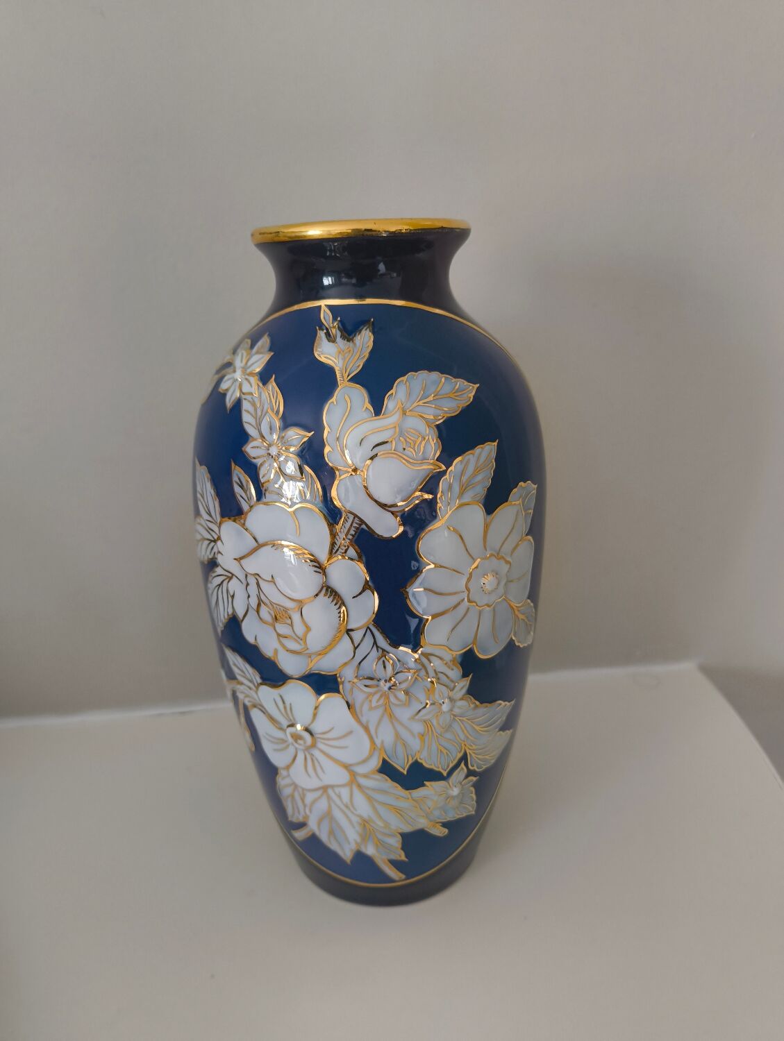 Cobalt blue porcelain vase from Limoges, France with floral pattern.