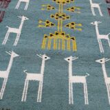 Blue carpet with gazelle patterns woven by hand