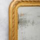 19th-century patinated mirror with a ribbon-style frame