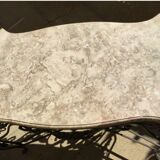 Wrought iron table with openwork flower belt. marble top