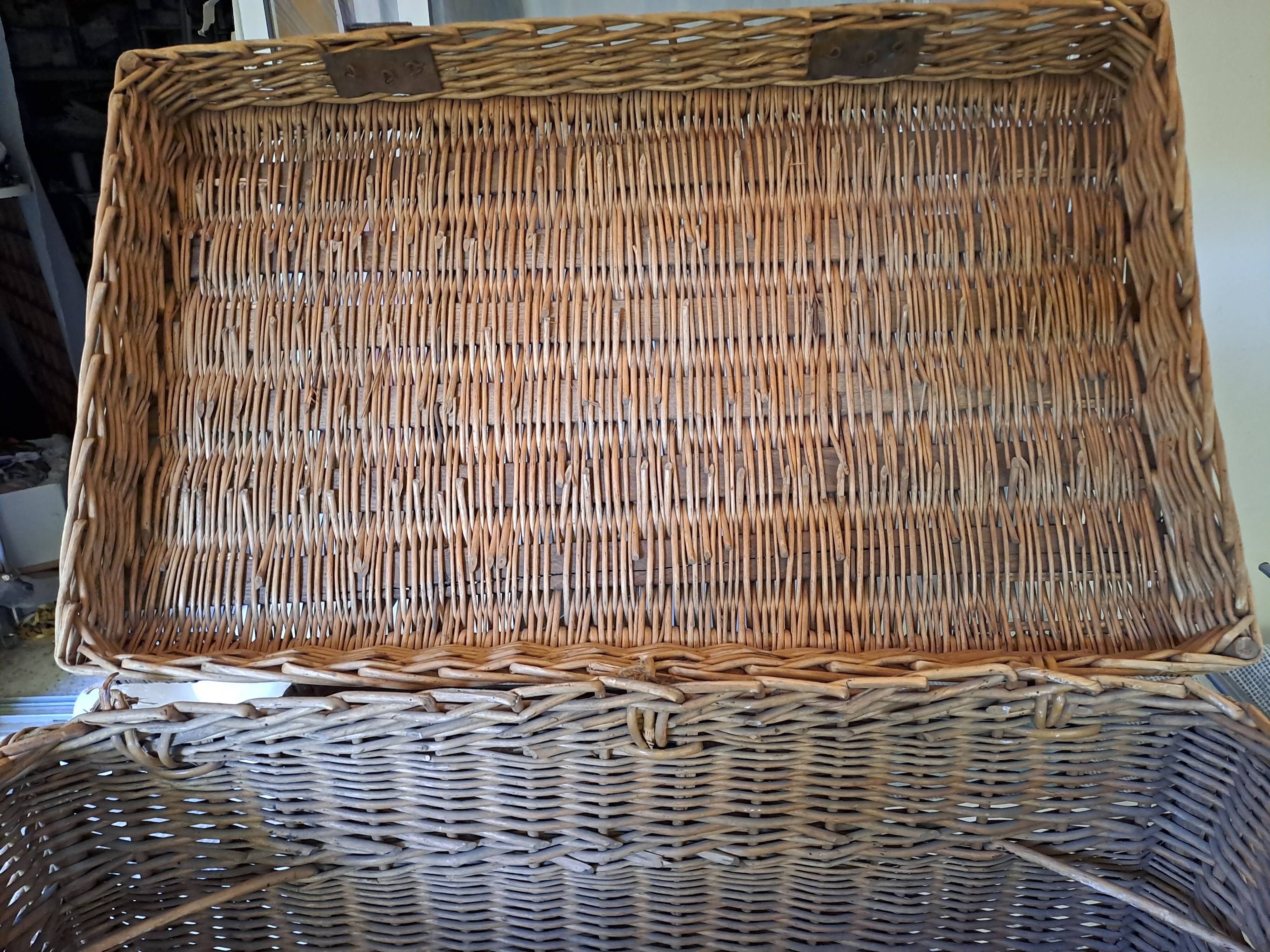 Wicker travel trunk XIX with metal clasps and handles.