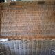 Wicker travel trunk XIX with metal clasps and handles.