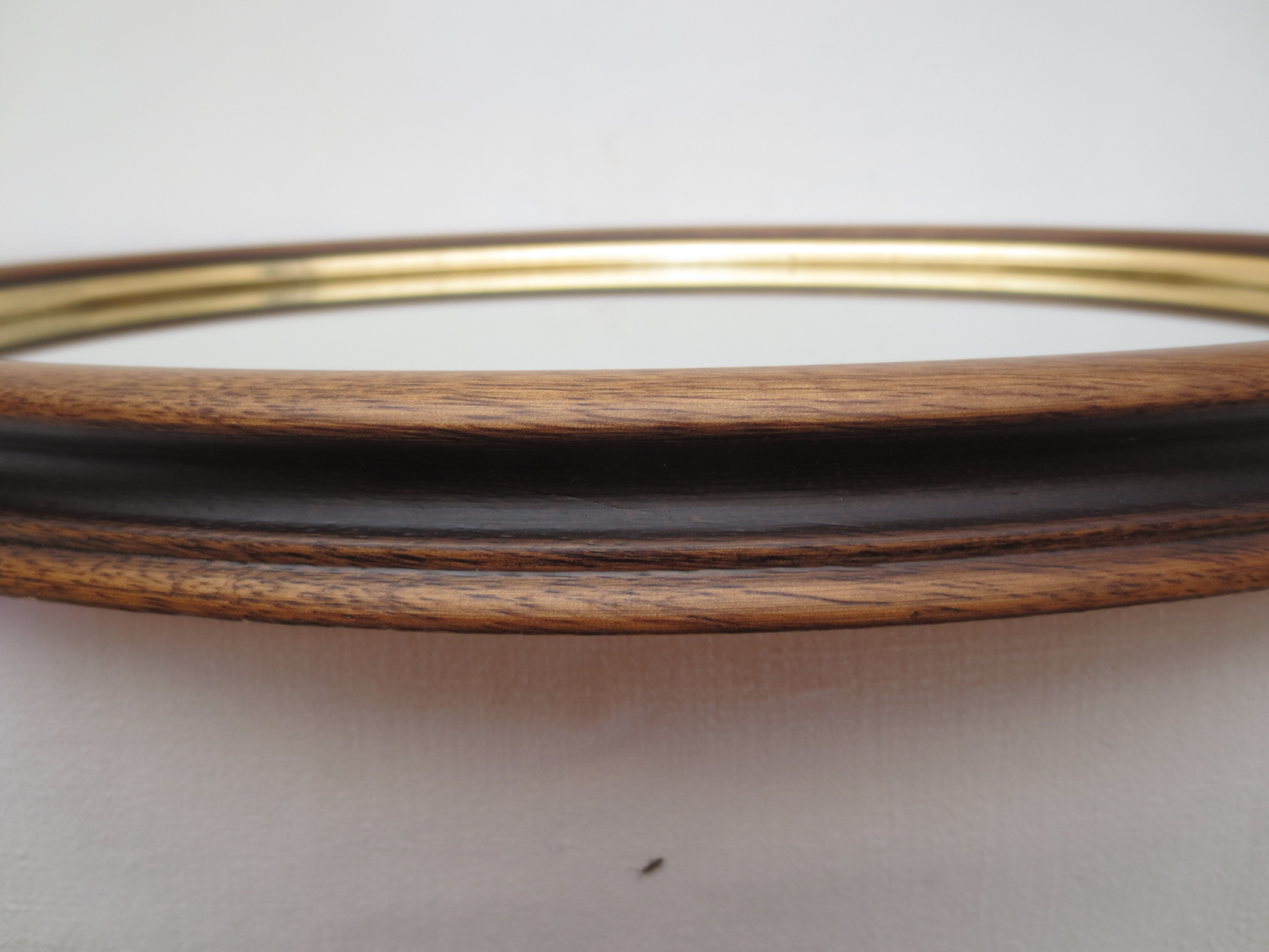 Old oval mirror, walnut wood tower, gilded border