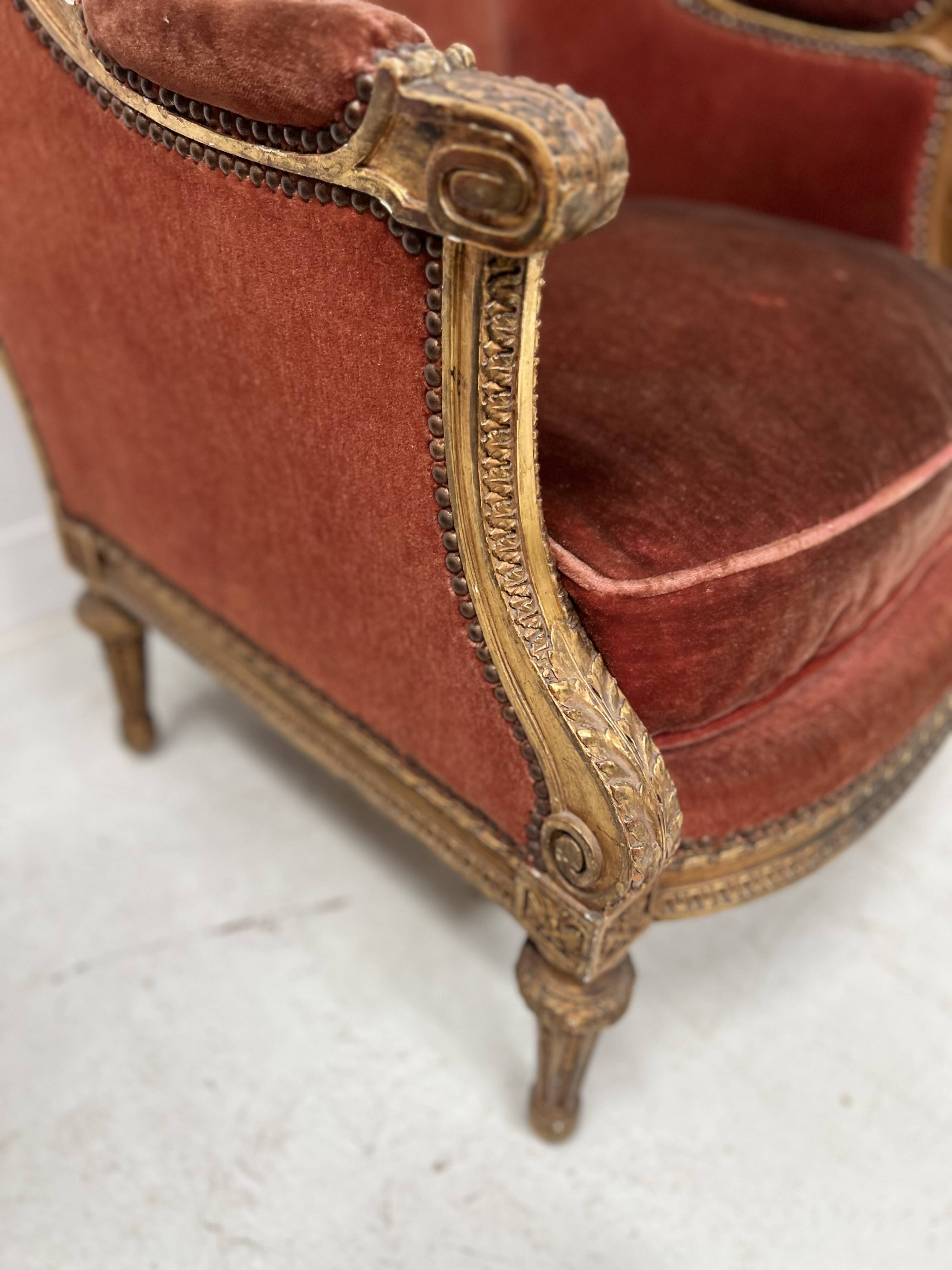 Two Louis XVI style wing chairs in gilded wood, 20th century