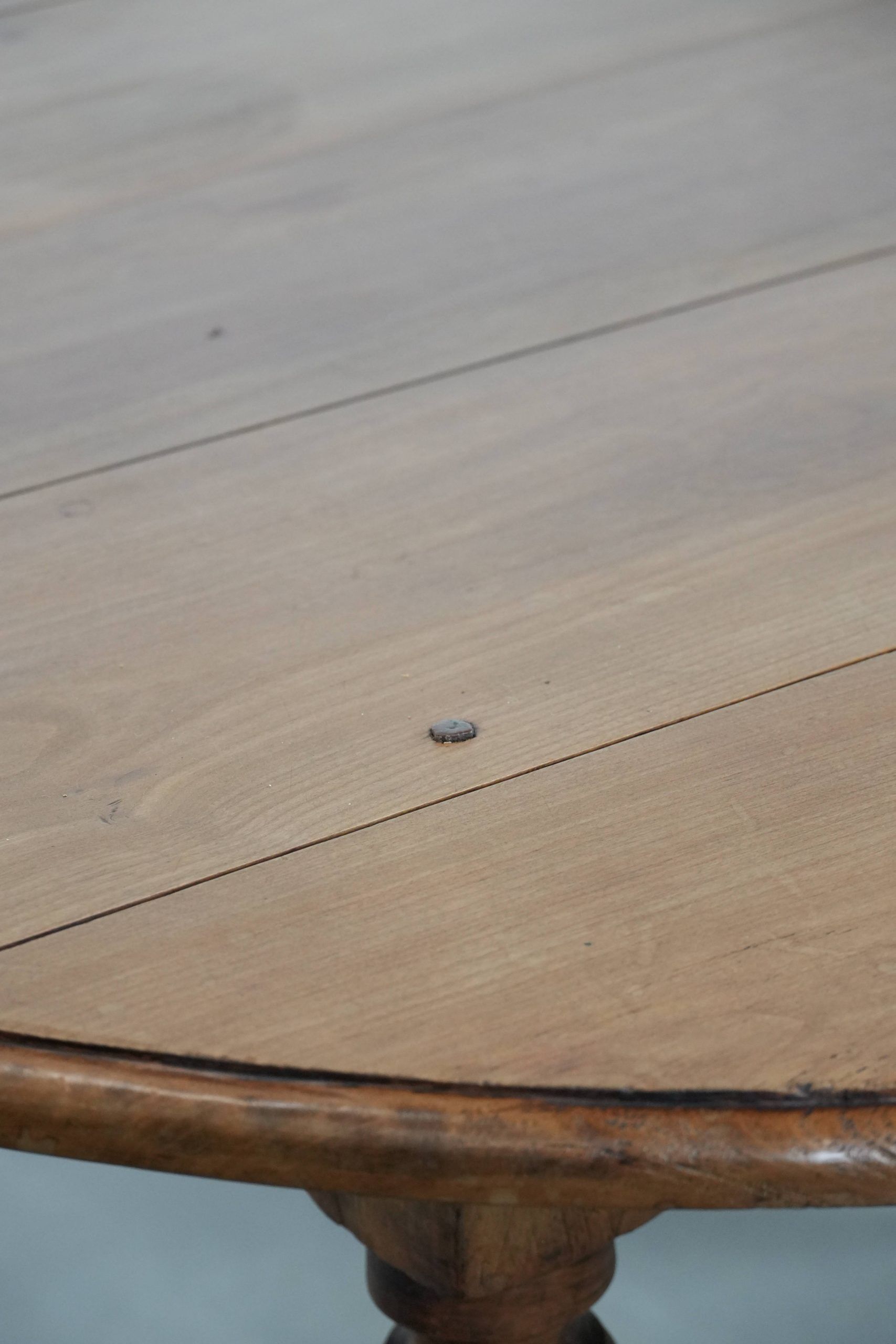 Antique English drop-leaf dining table made of walnut with elegant legs
