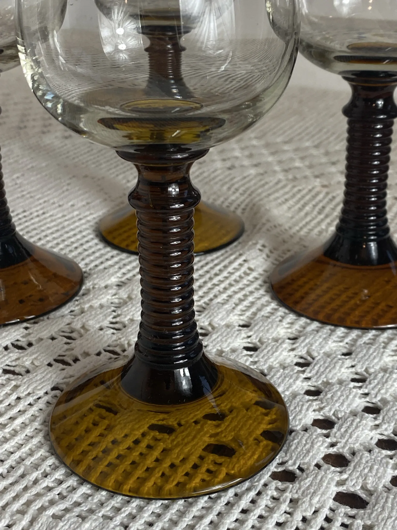 Footed glasses of the Roemer type, amber colour