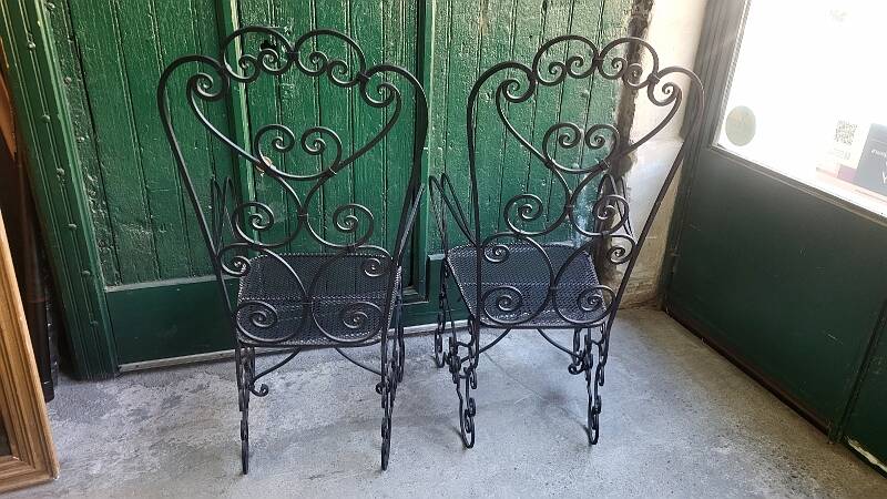 Pair of black wrought iron armchairs