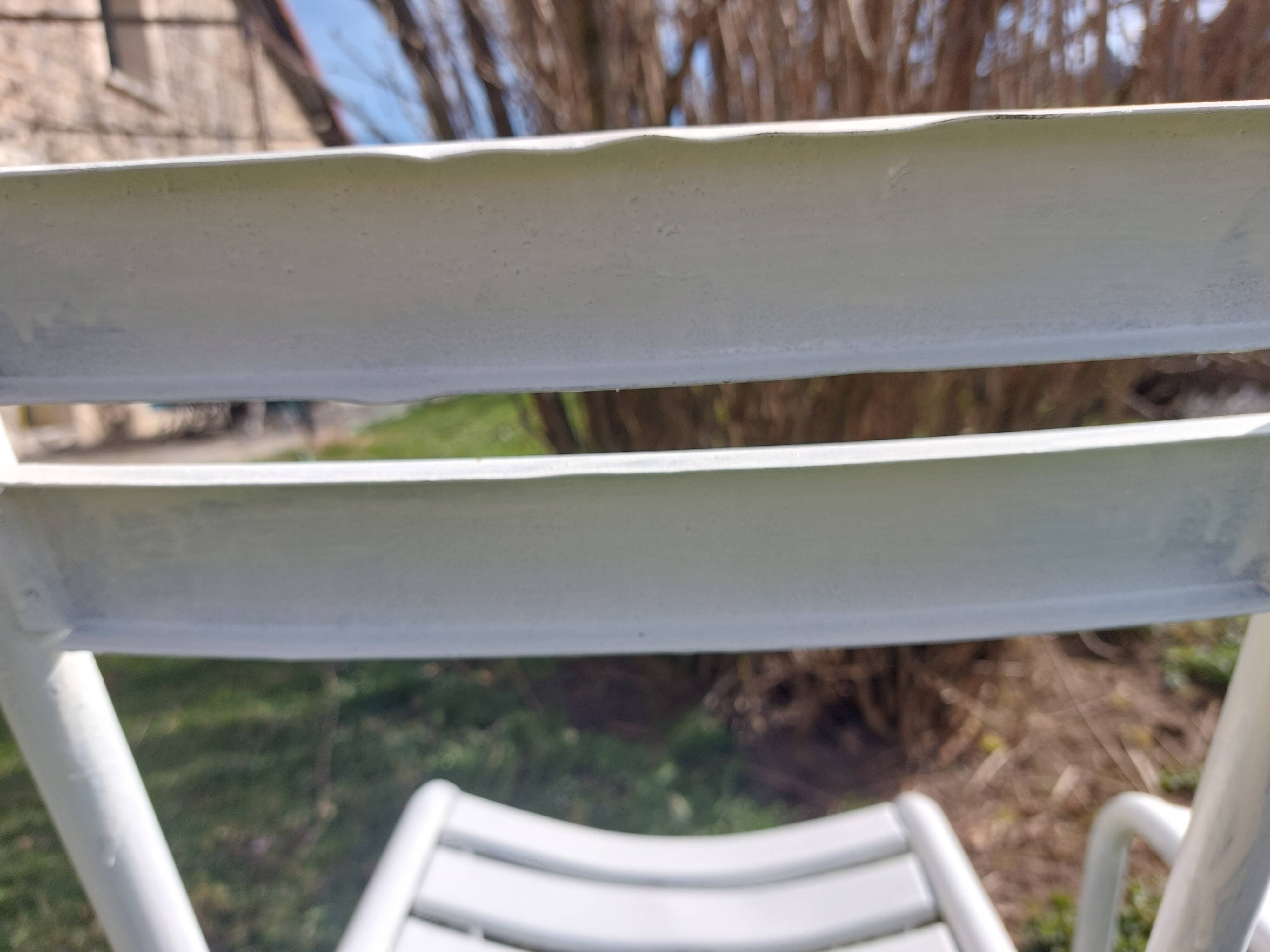 pair of white metal chairs, Tolix style