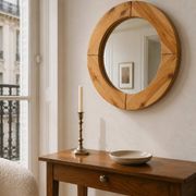 Round mirror in raw wood