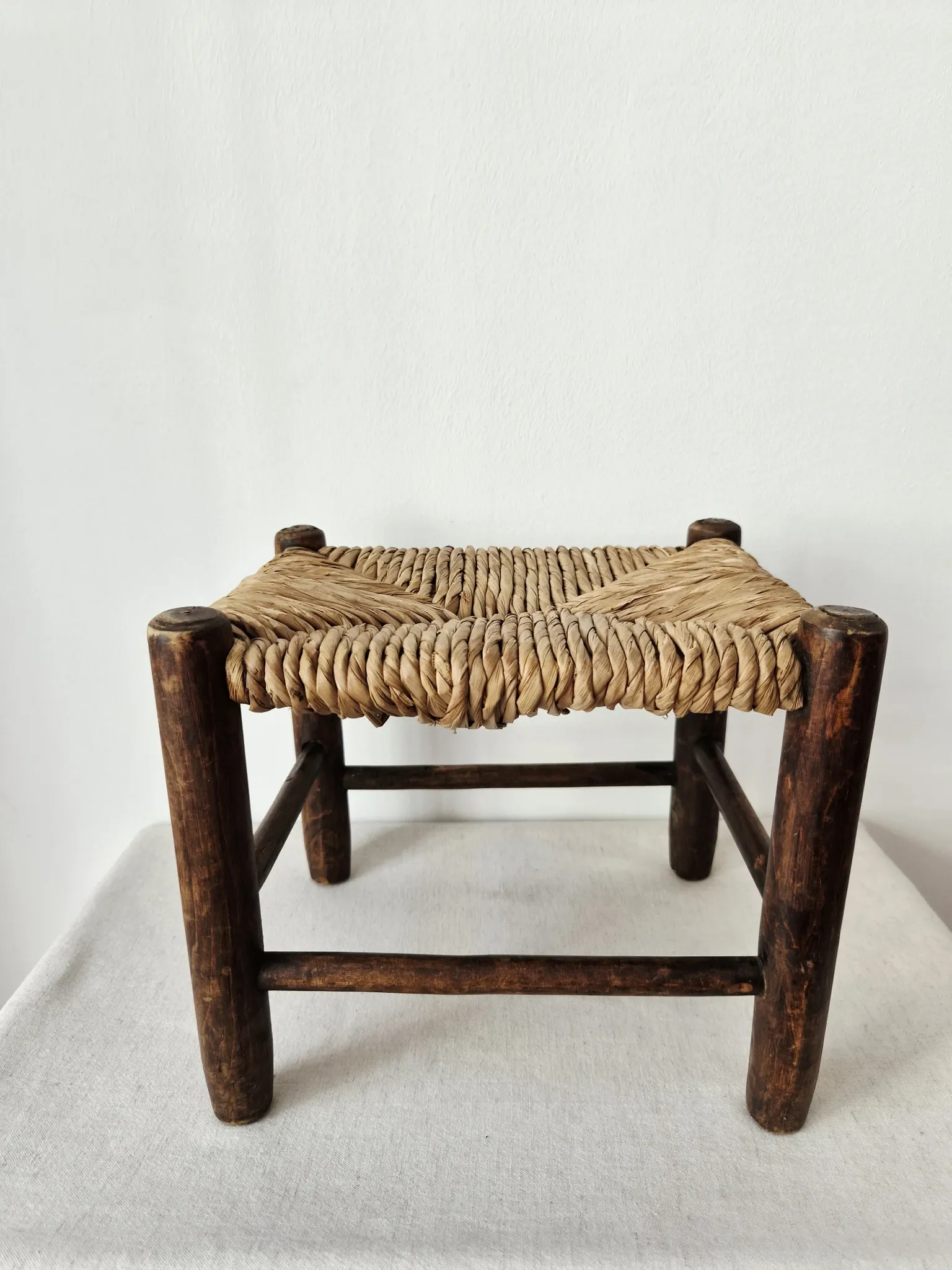 Small rustic vintage wooden and straw stool -