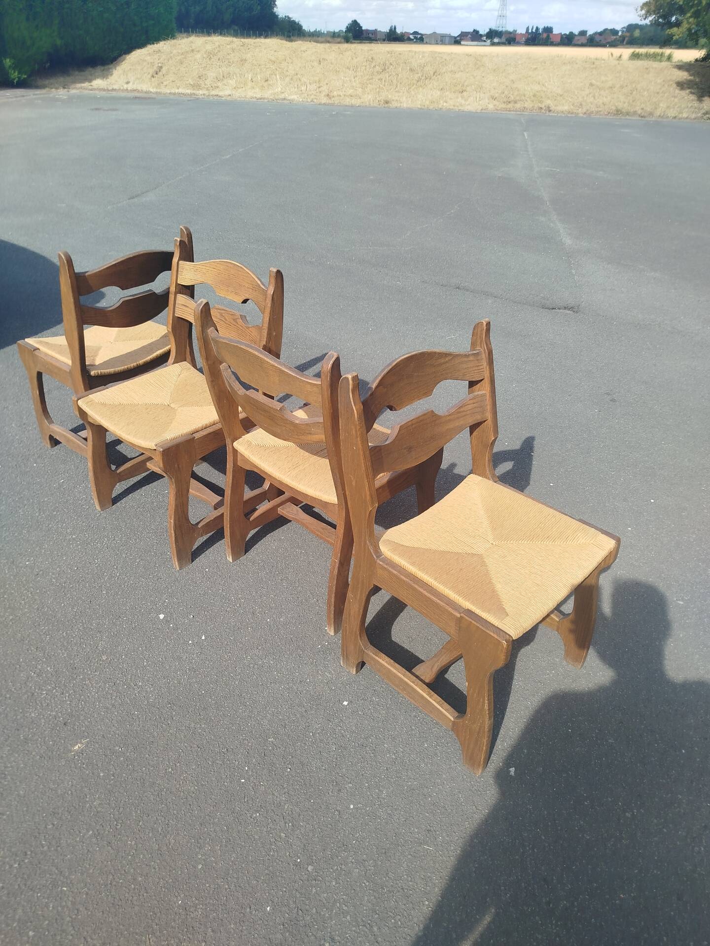 Set of 4 solid oak chairs with straw, in the style of Guillerm.