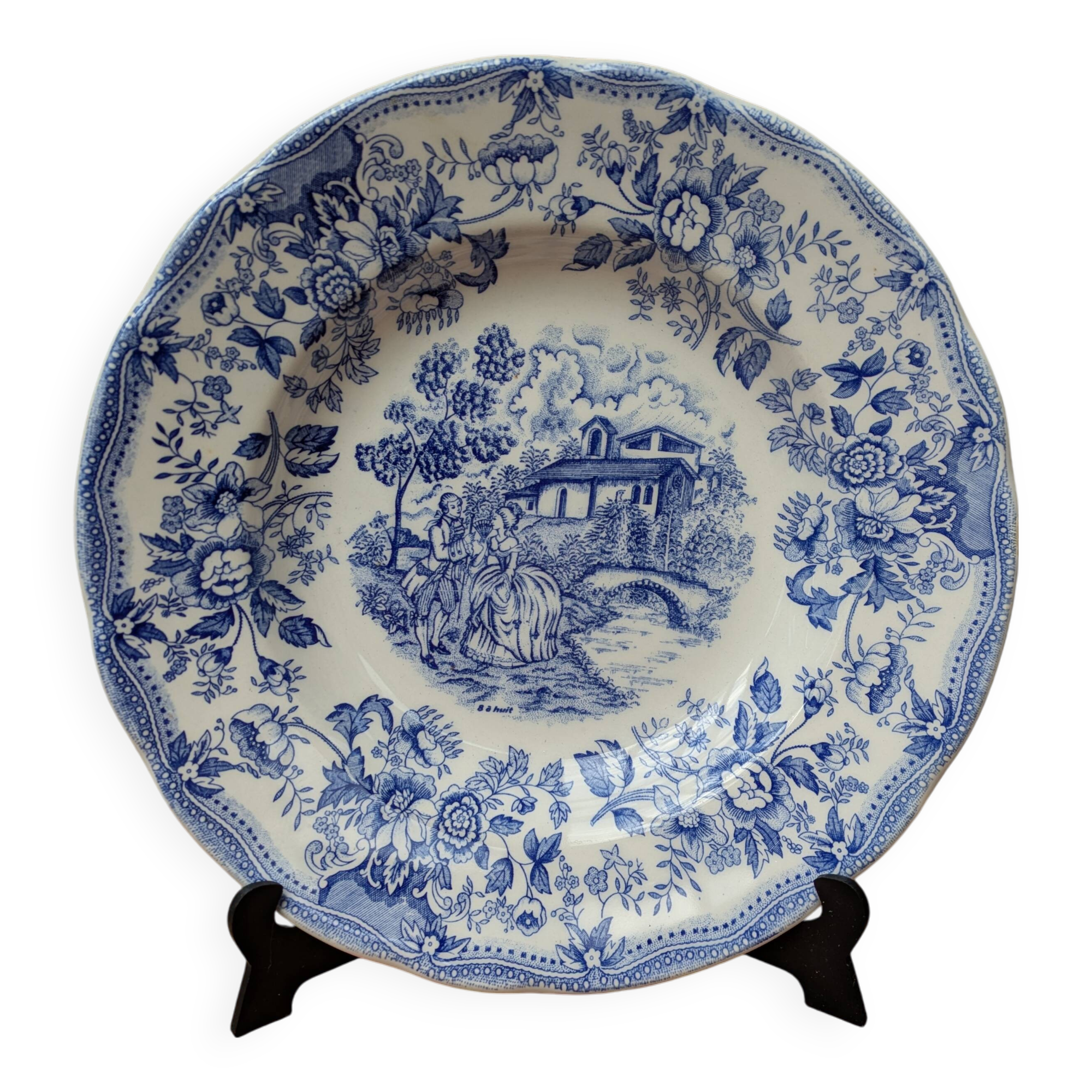 Old deep plate with blue floral pattern and gallant scene