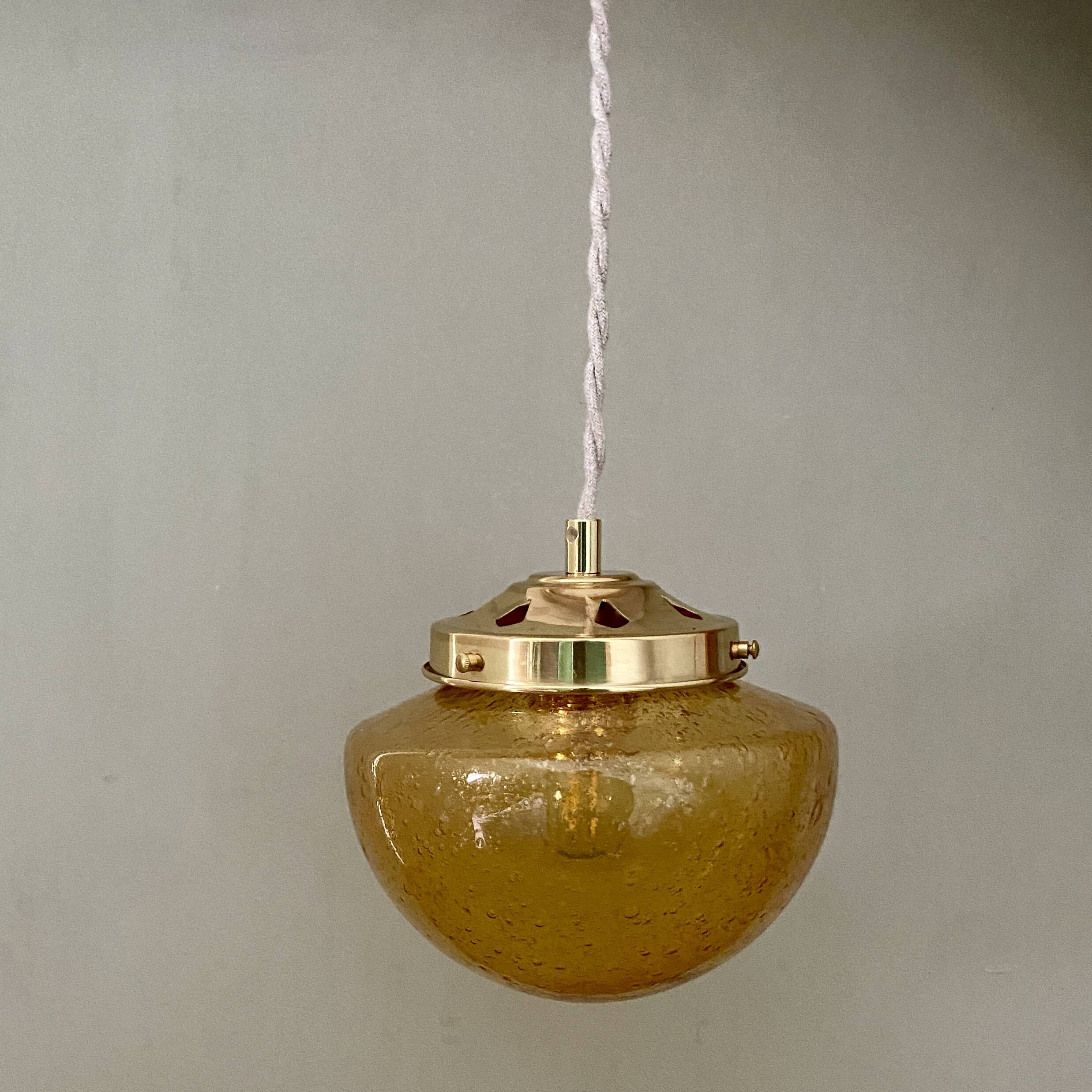 Vintage globe pendant light in bubbled amber glass