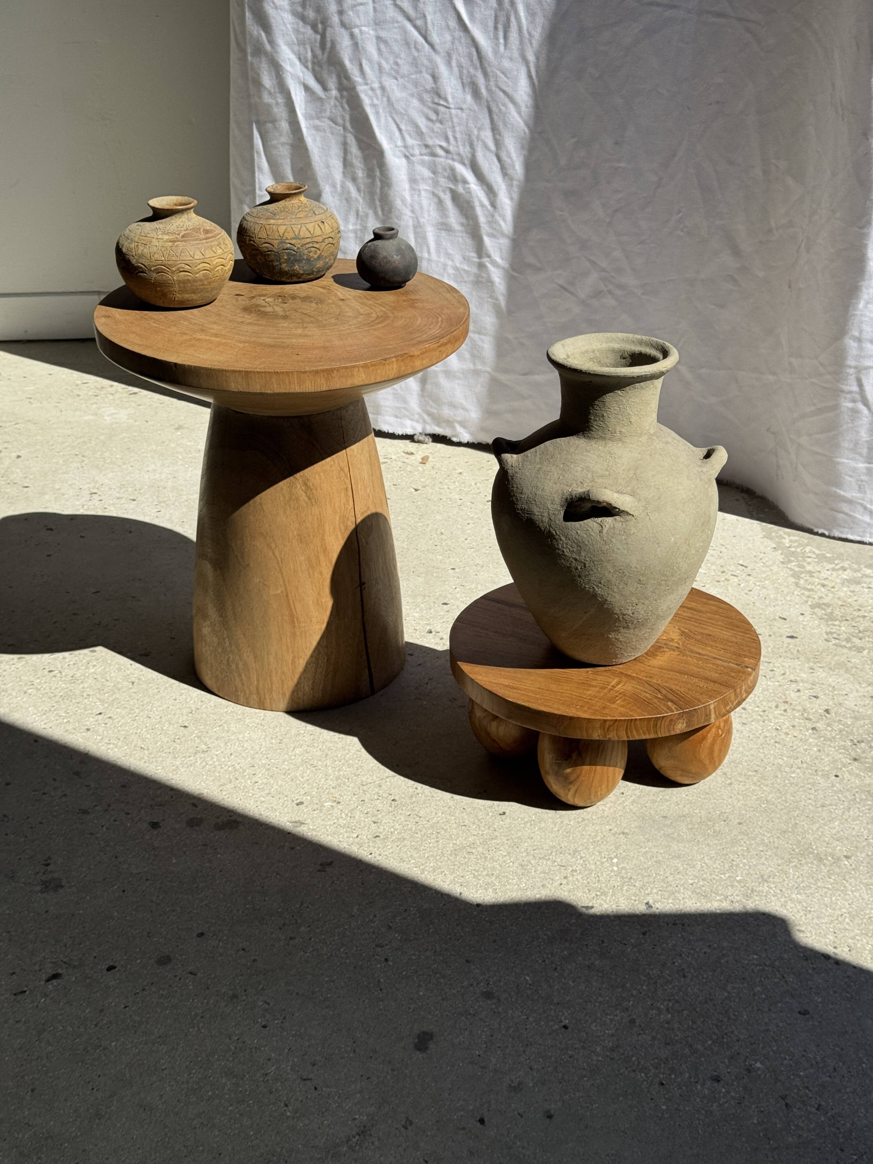 Light beige-grey Indonesian terracotta vase with 4 small handles and a high neck.