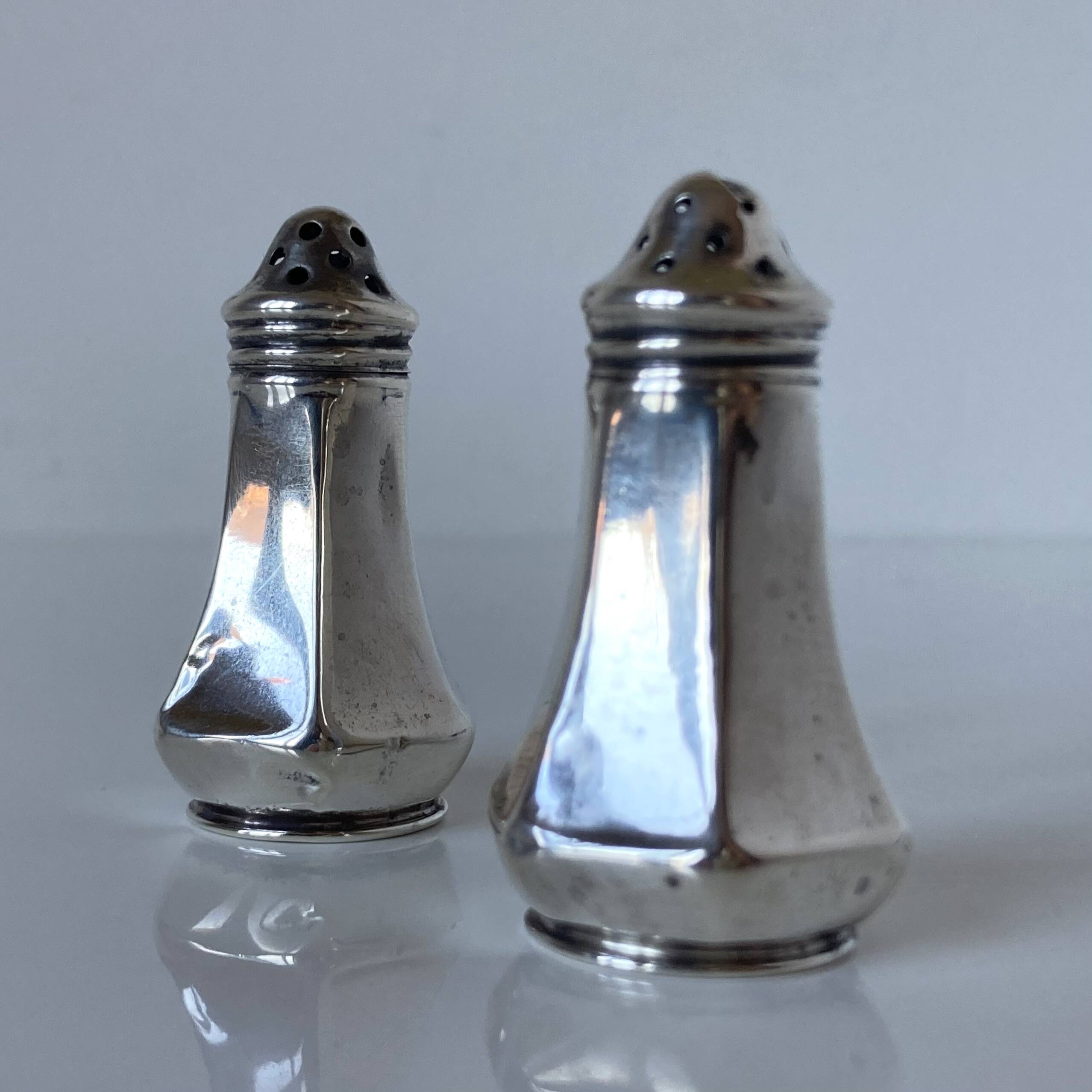 Antique salt and pepper shakers in solid English silver